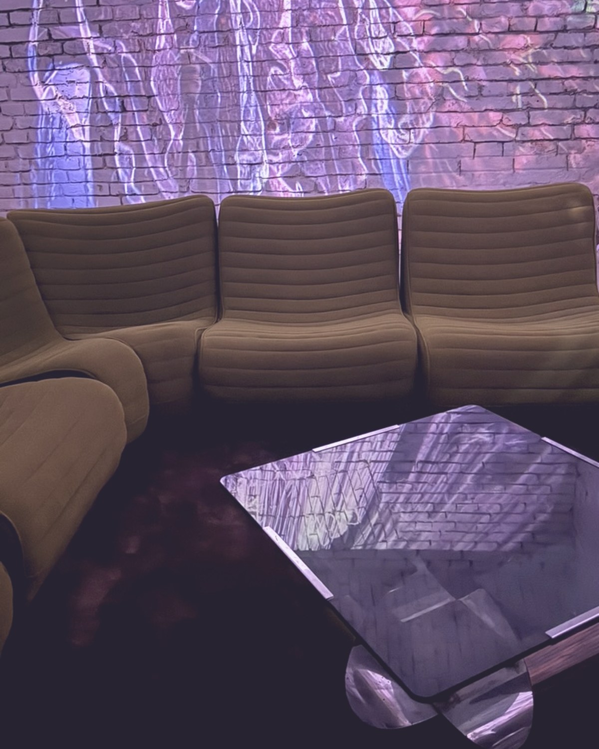 The lounge seating facing a glowing projection