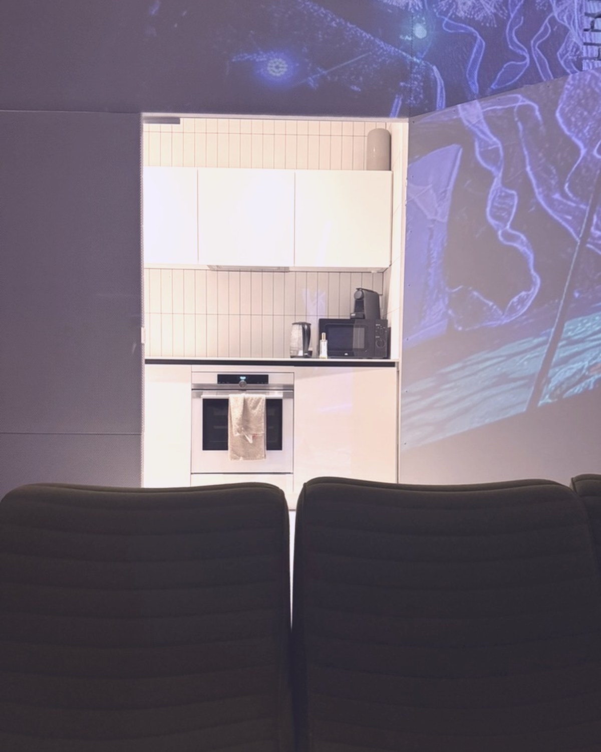 The kitchen area with projections running across the walls