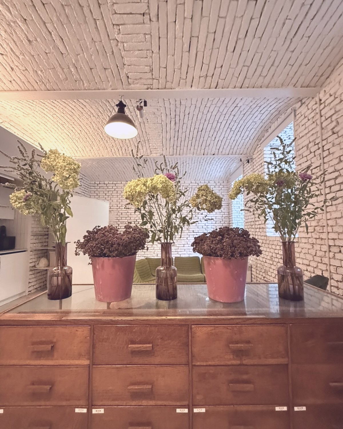 Flower arrangements on the wooden cabinet in daylight