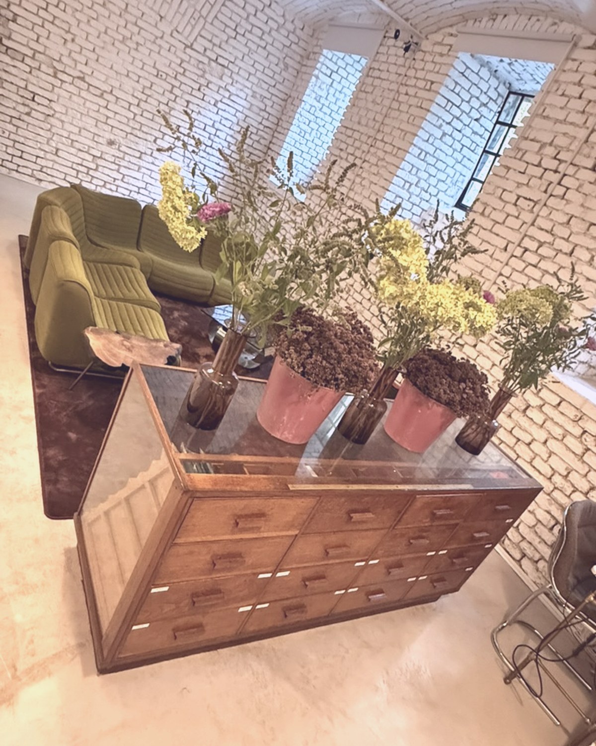 Vintage cabinet with flowers under the vaulted brick ceiling
